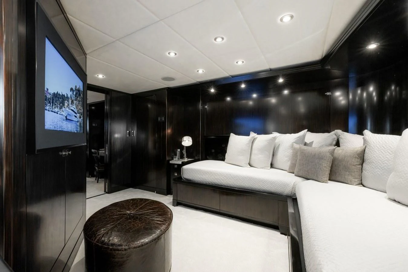 The yacht's interior features a cozy lounge area with plush seating and a large TV screen. aboard CARPE DIEM Yacht for Sale