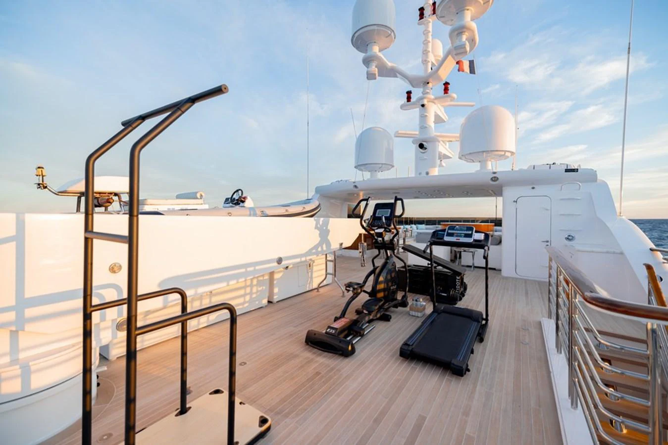 The sundeck features a well-equipped outdoor gym with stunning ocean views. aboard CARPE DIEM Yacht for Sale