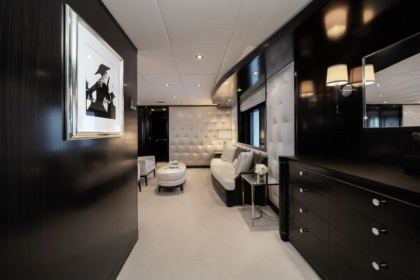 The stateroom features elegant dark wood paneling, plush seating, and sophisticated decor. aboard CARPE DIEM Yacht for Sale