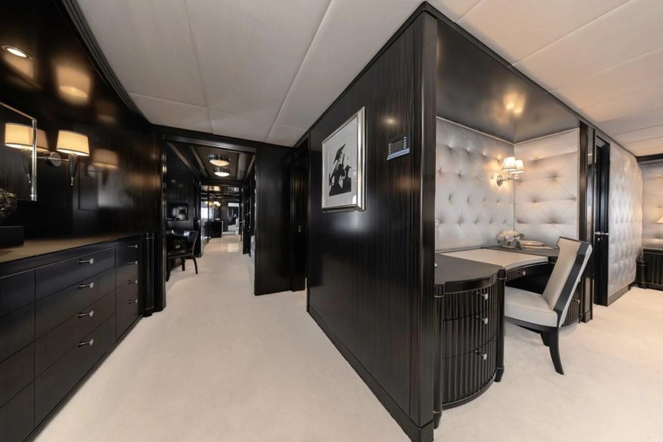The yacht's interior features a luxurious hallway with elegant dark wood paneling and plush furnishings. aboard CARPE DIEM Yacht for Sale