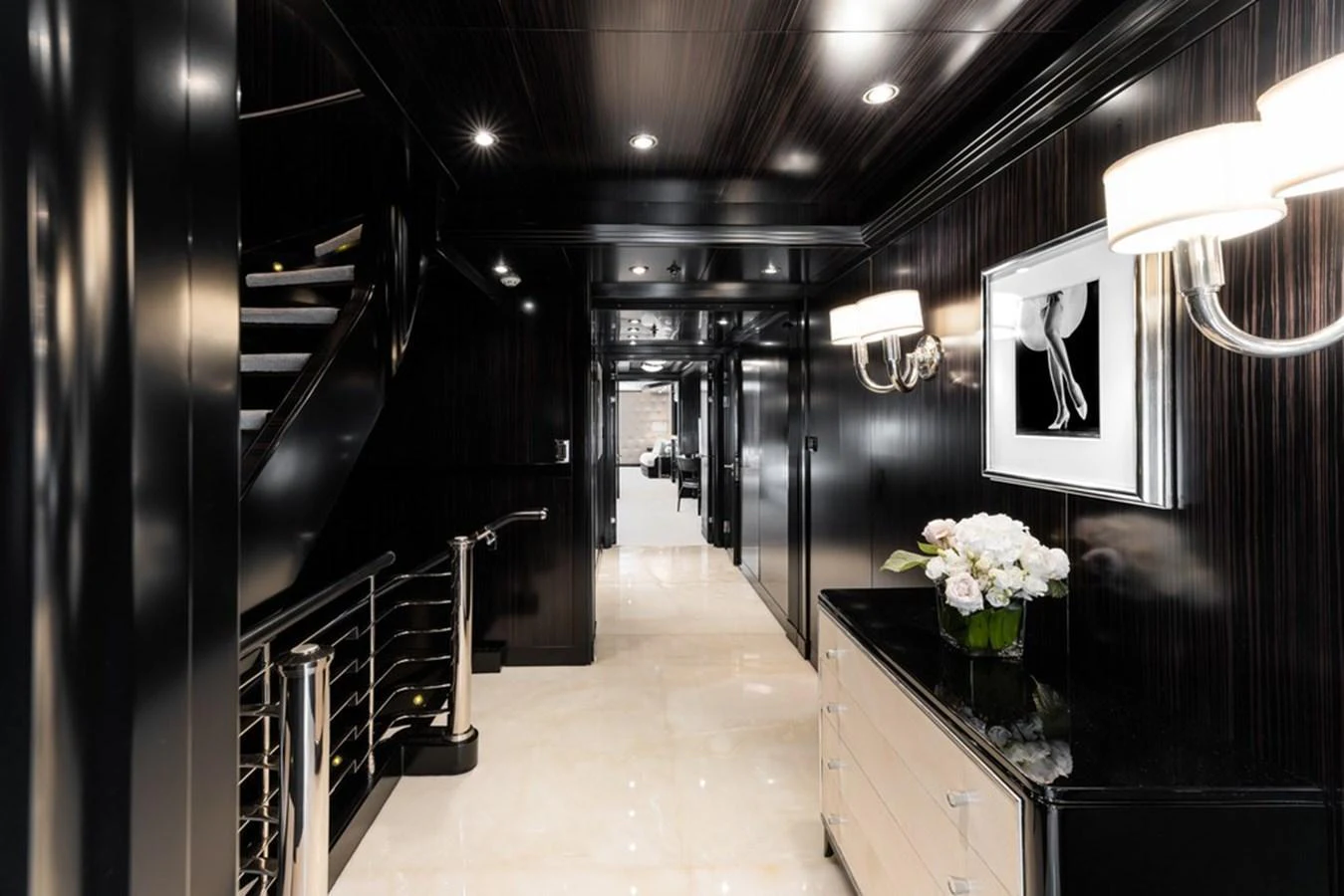 A sleek and modern yacht interior hallway with elegant lighting and decor. aboard CARPE DIEM Yacht for Sale