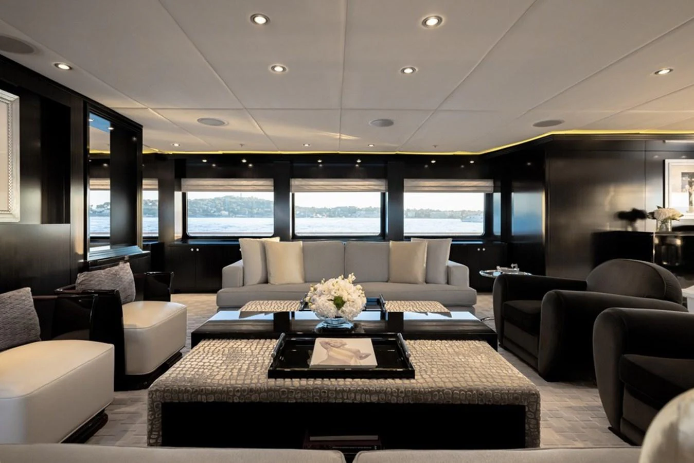 The salon features luxurious seating with panoramic windows offering stunning views. aboard CARPE DIEM Yacht for Sale