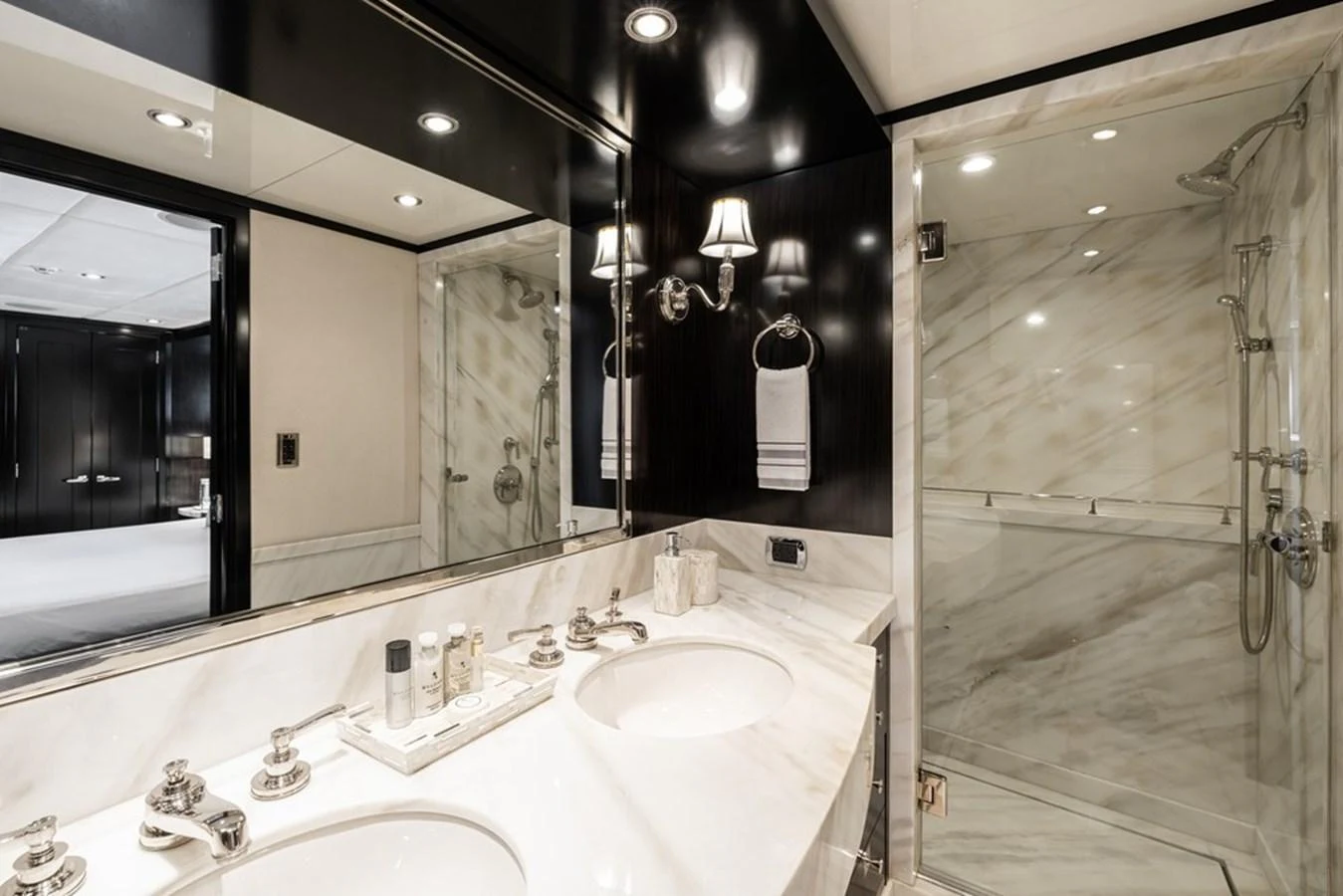 A luxurious bathroom with a double sink vanity and a spacious glass-enclosed shower. aboard CARPE DIEM Yacht for Sale