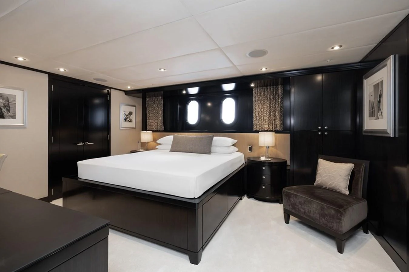 The master stateroom features a luxurious bed with elegant furnishings and ample natural light. aboard CARPE DIEM Yacht for Sale