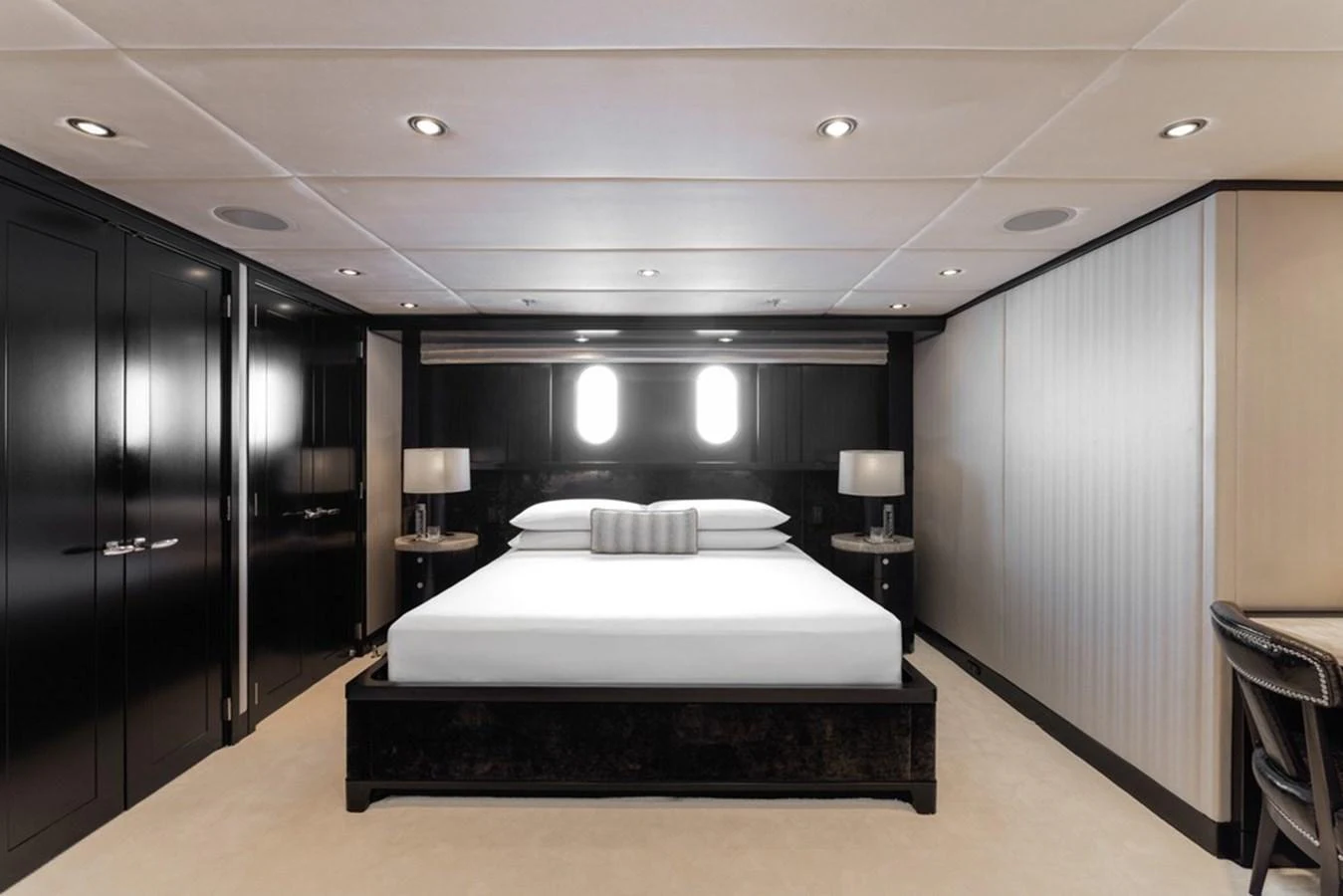A luxurious stateroom featuring a large bed, elegant lighting, and modern decor. aboard CARPE DIEM Yacht for Sale