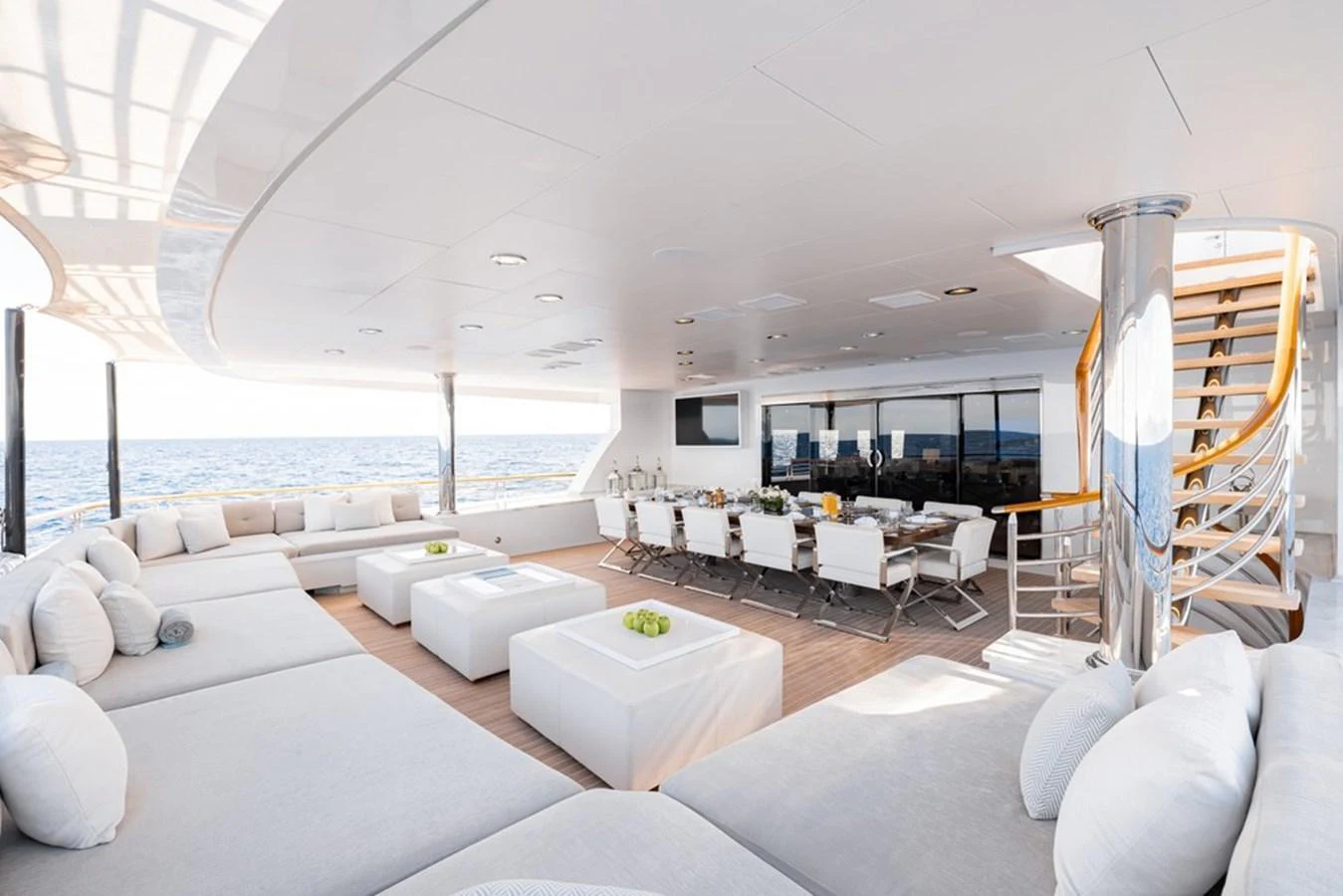 The aft deck features a spacious and elegant seating area with a dining table, perfect for alfresco dining and relaxation. aboard CARPE DIEM Yacht for Sale