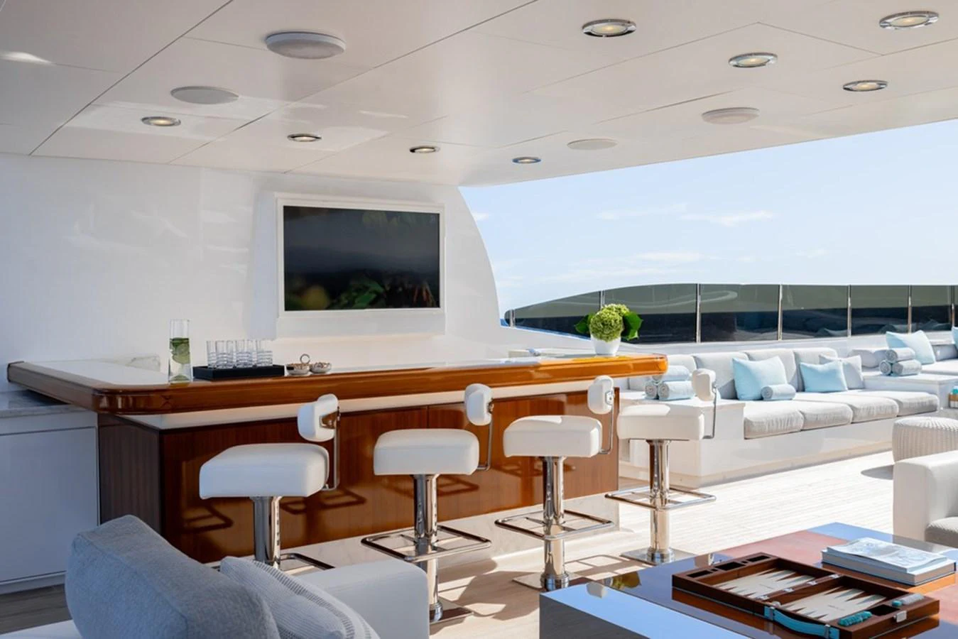 This luxurious yacht features a stylish bar area with comfortable seating and a sleek design. aboard CARPE DIEM Yacht for Sale