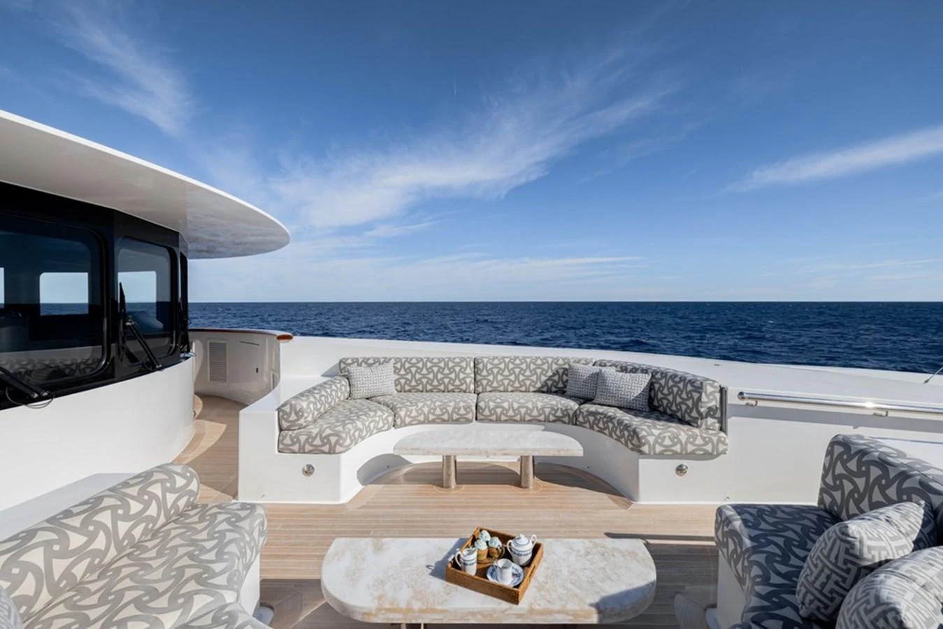 The aft deck features a stylish seating area with a coffee table, perfect for enjoying the ocean view. aboard CARPE DIEM Yacht for Sale