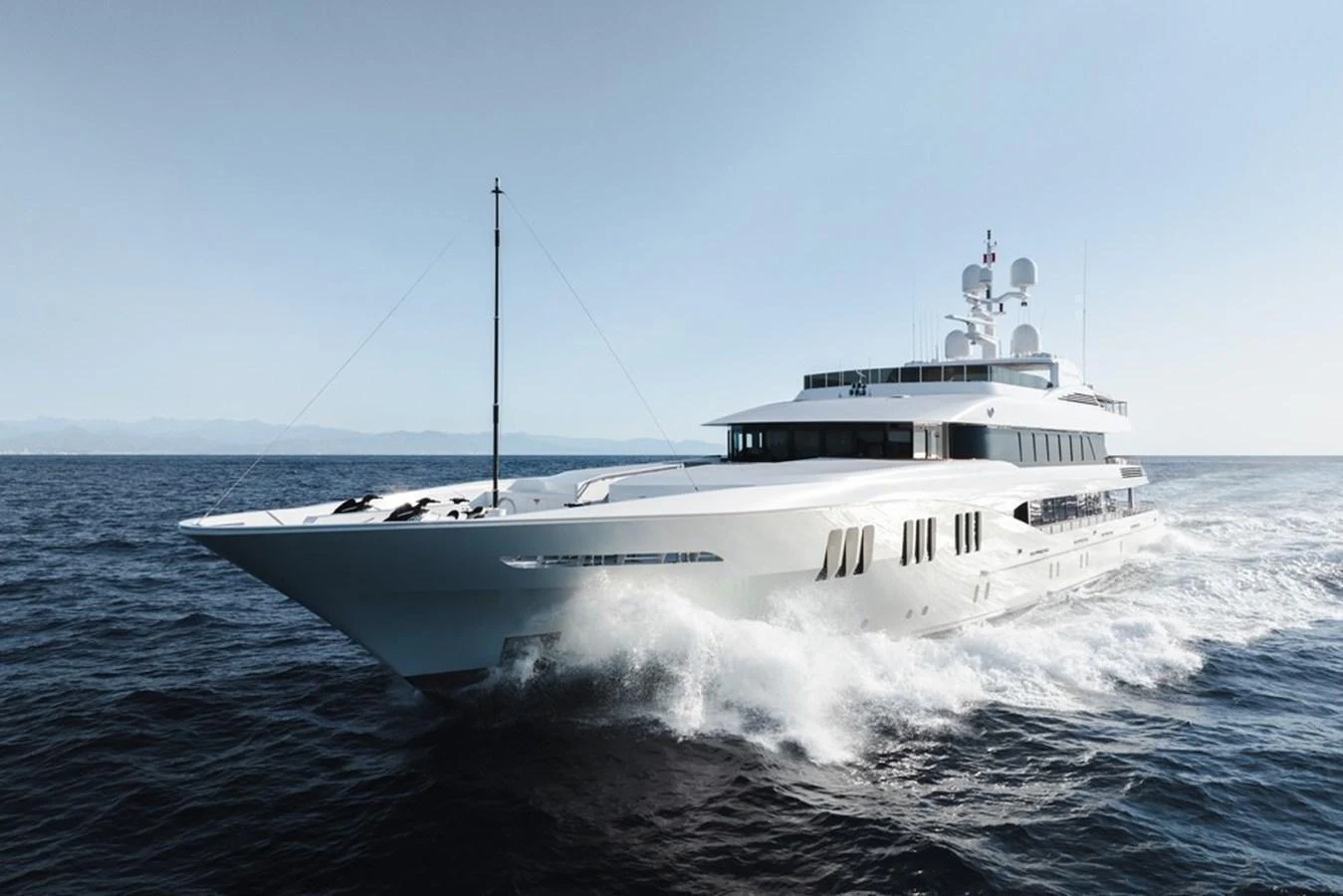 A sleek and modern yacht cruising on the open sea under clear skies. aboard CARPE DIEM Yacht for Sale