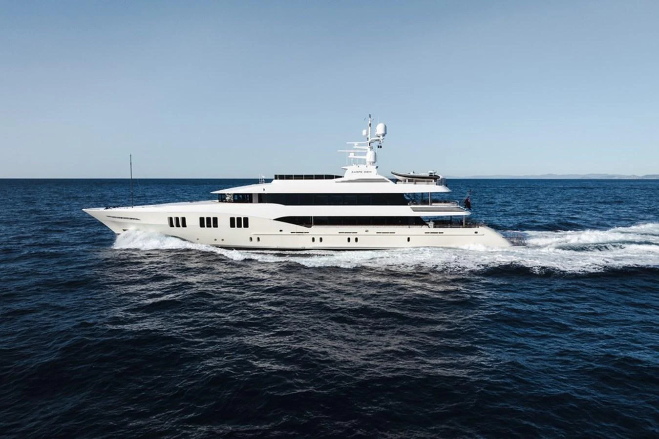 A sleek and modern yacht glides effortlessly through the open sea. aboard CARPE DIEM Yacht for Sale