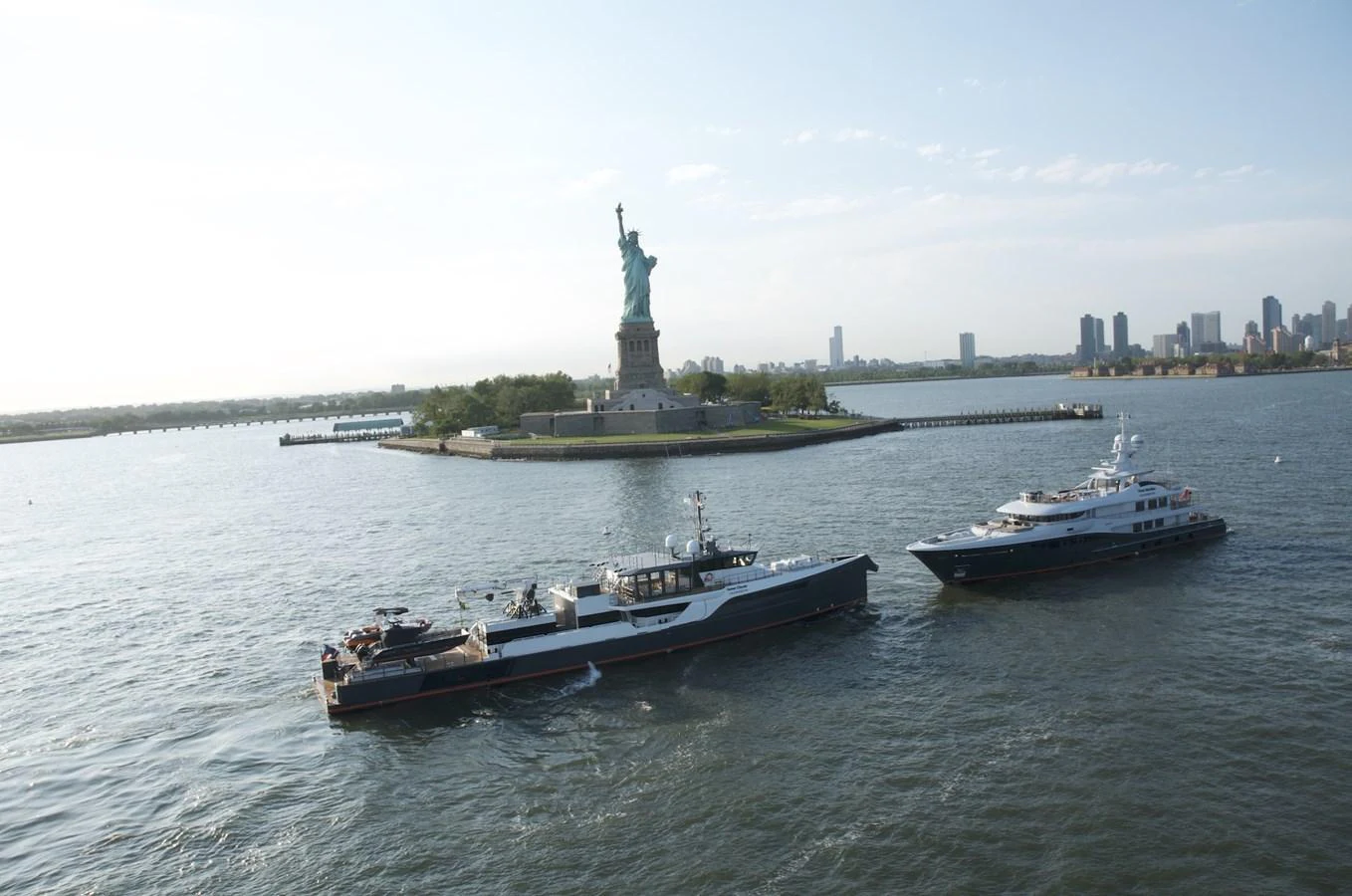 Two yachts are sailing near the Statue of Liberty on a clear day. aboard GENE CHASER Yacht for Sale