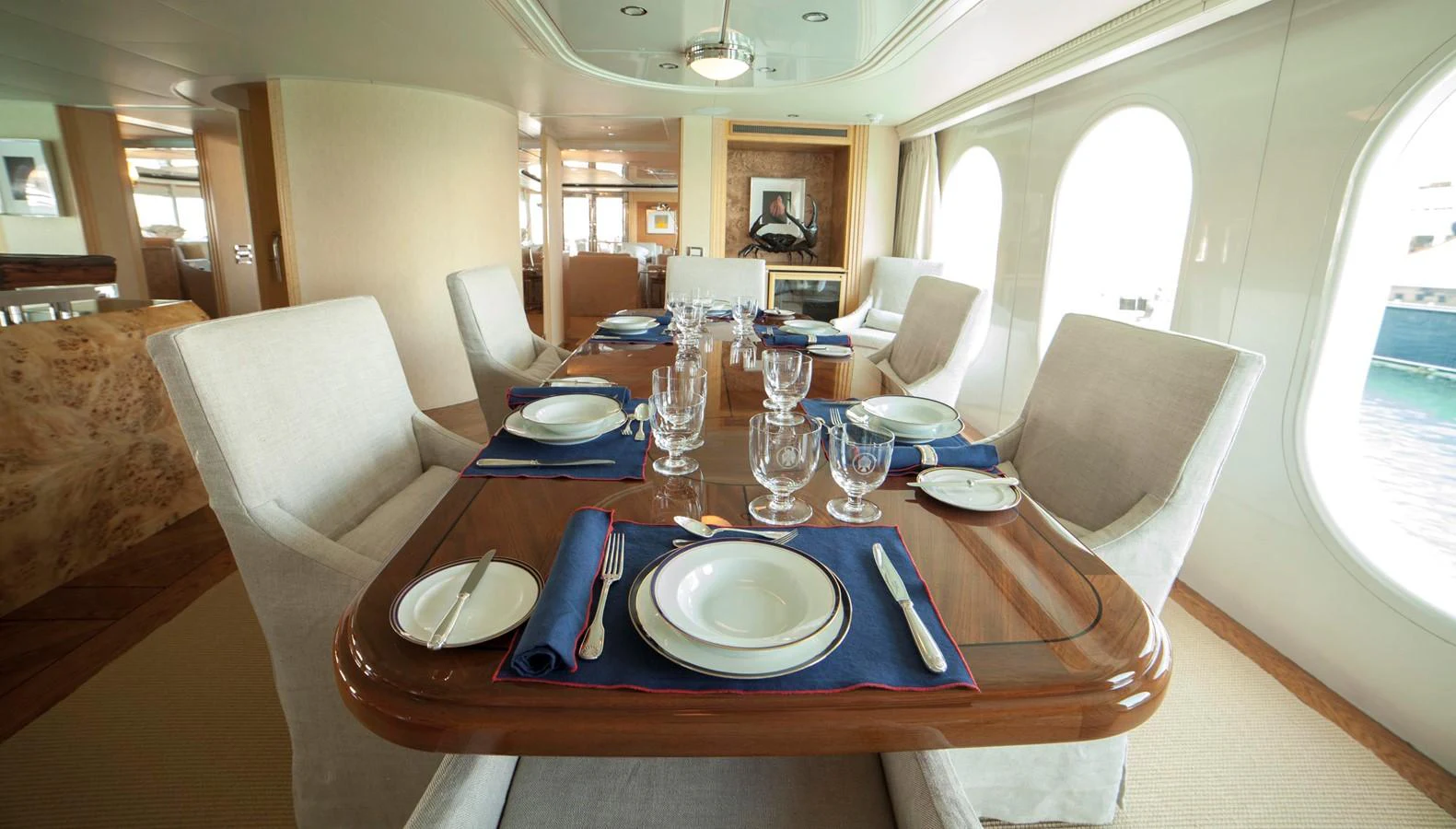 The elegant dining area features a beautifully set table with plush seating and large windows offering scenic views. aboard OCEANA I Yacht for Sale