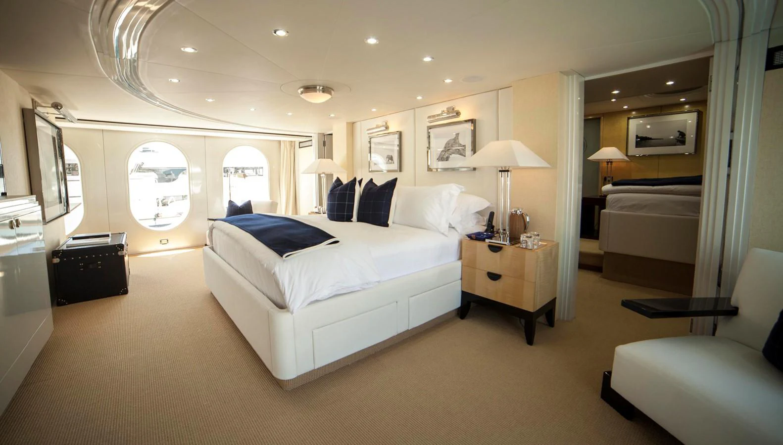 The master stateroom features a luxurious bed with elegant decor and ample natural light from large windows. aboard OCEANA I Yacht for Sale
