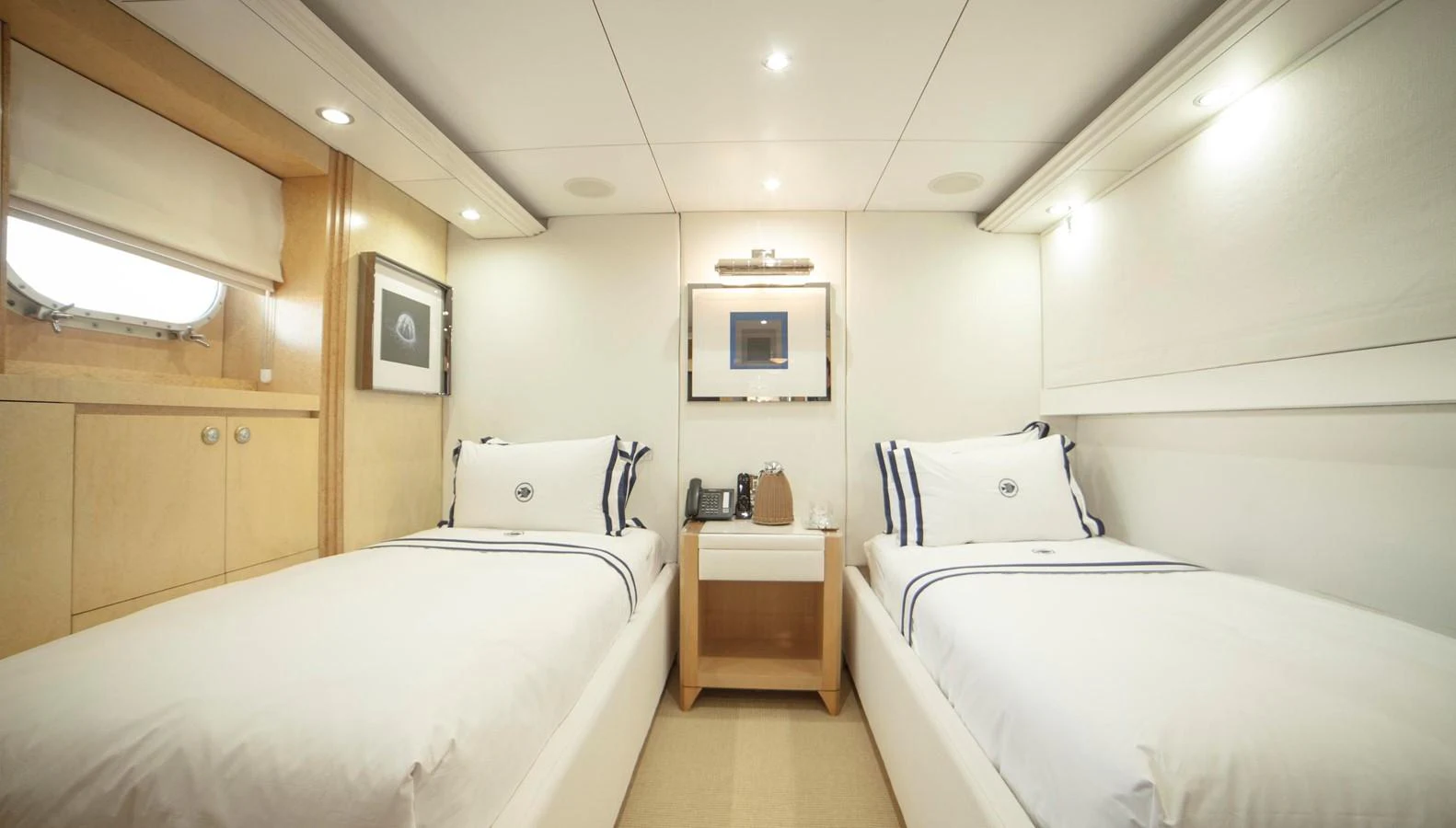 The twin stateroom features two comfortable single beds with elegant bedding and soft lighting. aboard OCEANA I Yacht for Sale