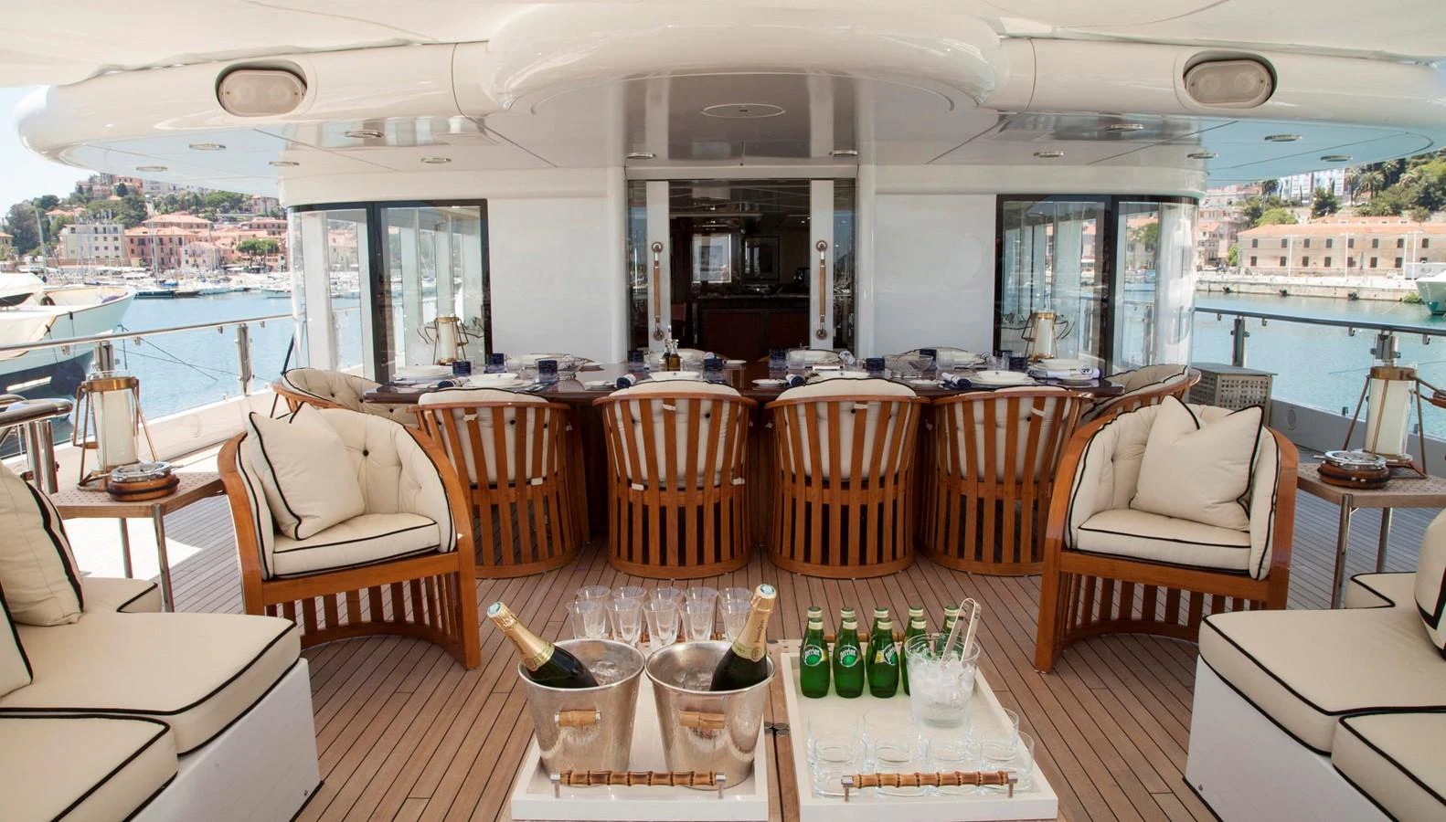 The aft deck features an elegant dining area with comfortable seating and a well-stocked bar, perfect for entertaining guests. aboard OCEANA I Yacht for Sale