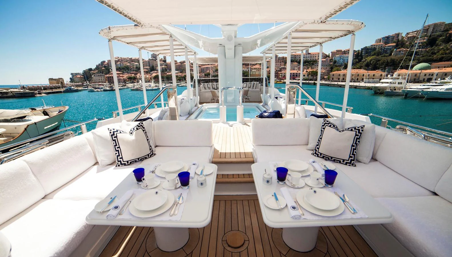 The sundeck offers a luxurious outdoor dining area with stunning views of the marina. aboard OCEANA I Yacht for Sale