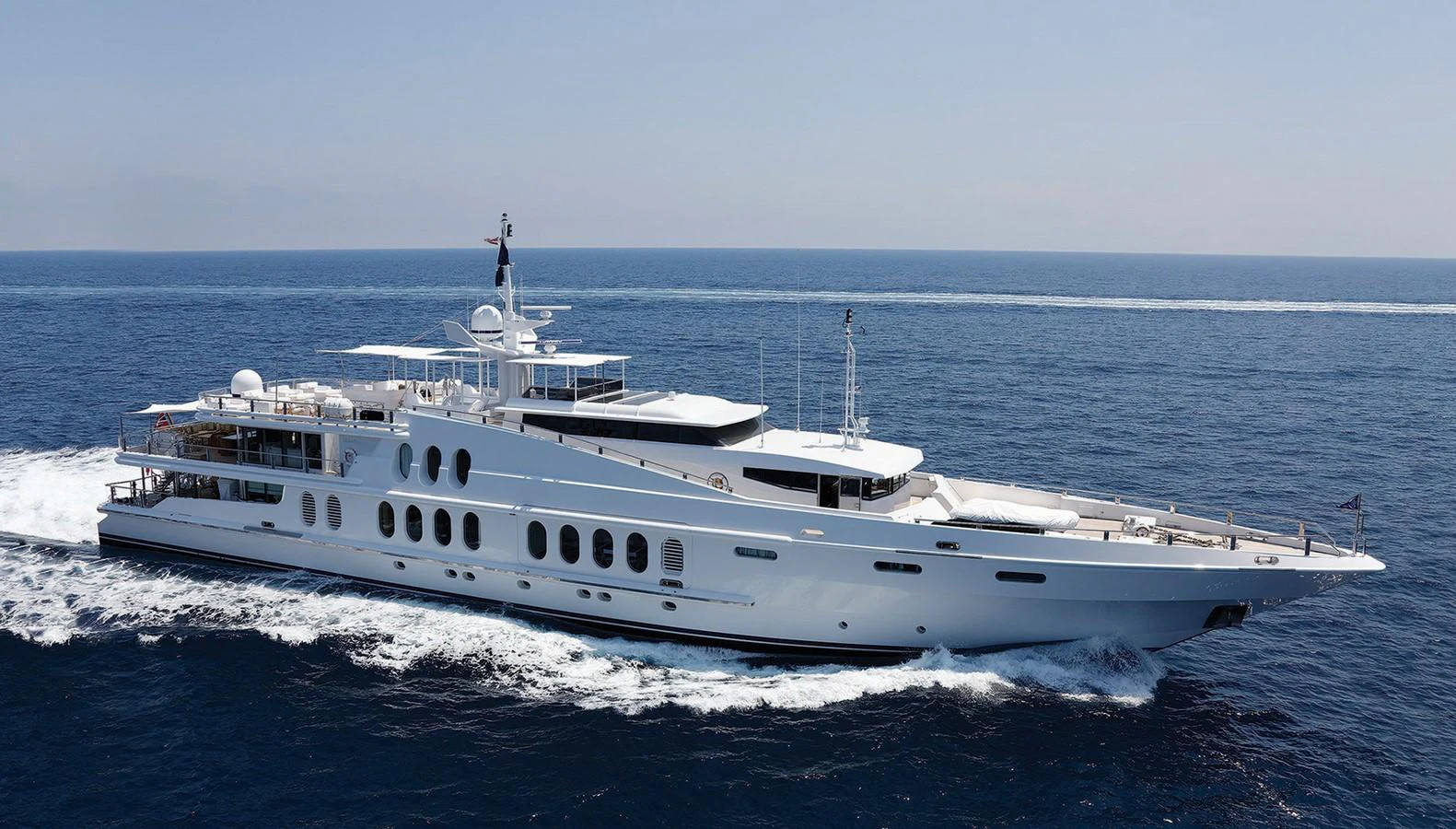 A luxurious yacht cruises through the open sea, showcasing its sleek design and elegant profile. aboard OCEANA I Yacht for Sale