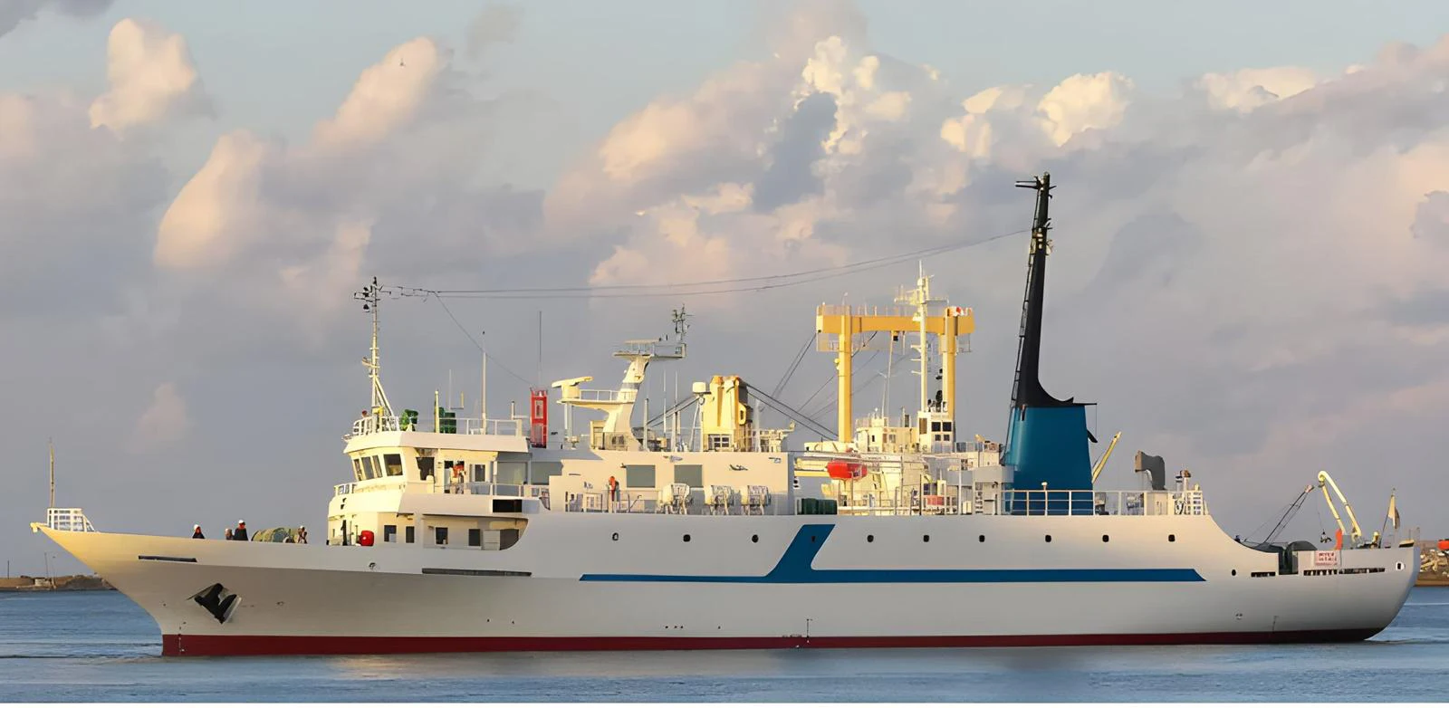 A well-maintained yacht is captured in profile, showcasing its sleek design and spacious deck under a serene sky. aboard CUSTOM Yacht for Sale