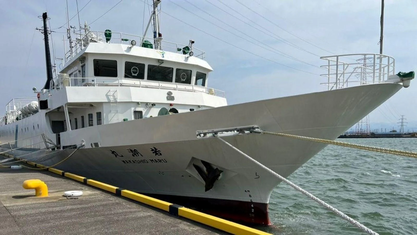 A sleek yacht is docked at the pier, showcasing its impressive bow and clean lines. aboard CUSTOM Yacht for Sale