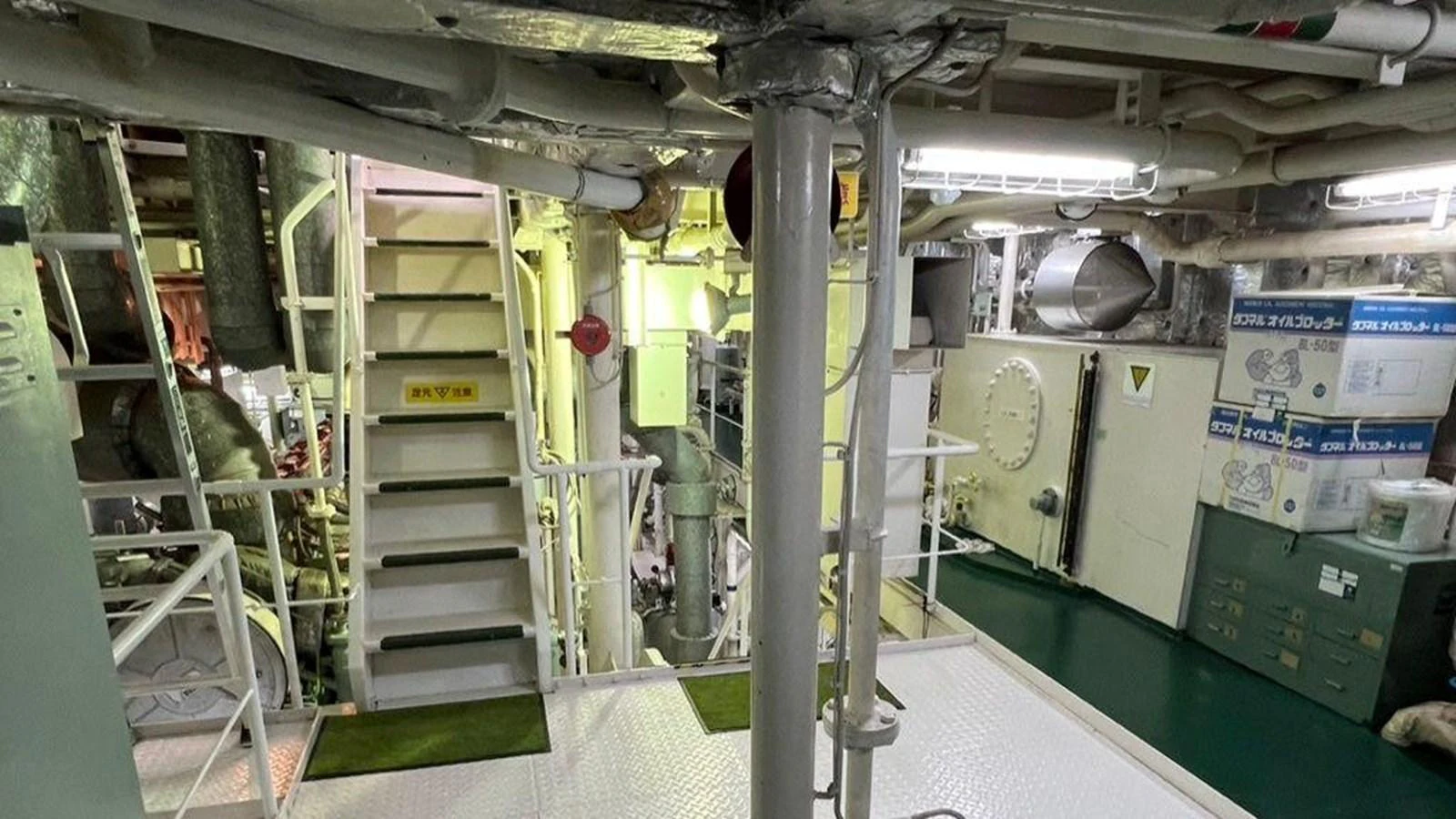 The image showcases the engine room of the yacht, featuring various machinery and equipment. aboard CUSTOM Yacht for Sale