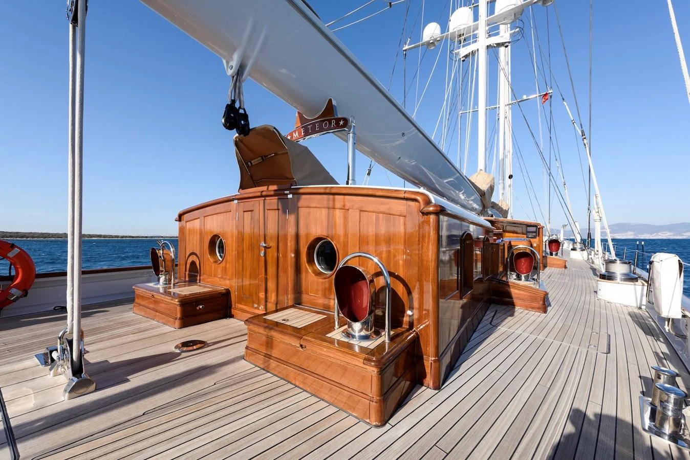 The yacht's deck features polished woodwork and a sleek design, perfect for enjoying the open sea. aboard METEOR Yacht for Sale
