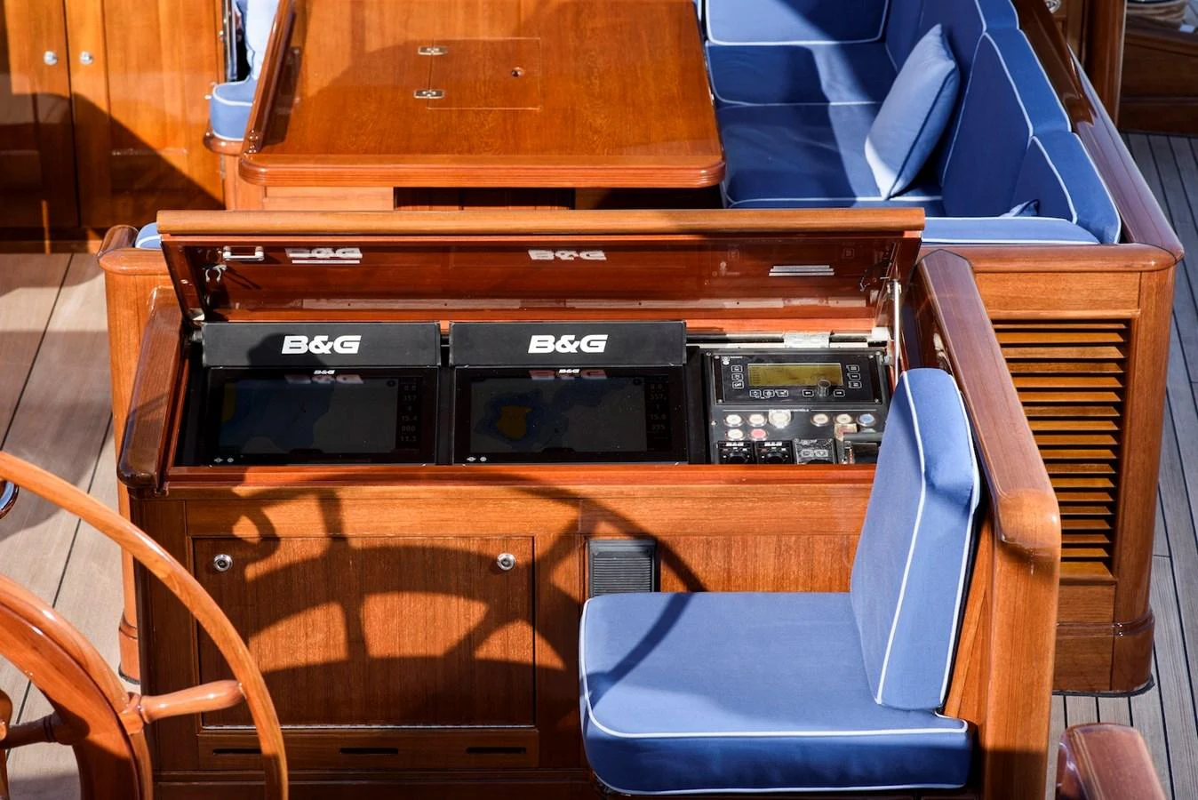 The yacht's helm features sophisticated navigation equipment and comfortable seating with wooden finishes. aboard METEOR Yacht for Sale