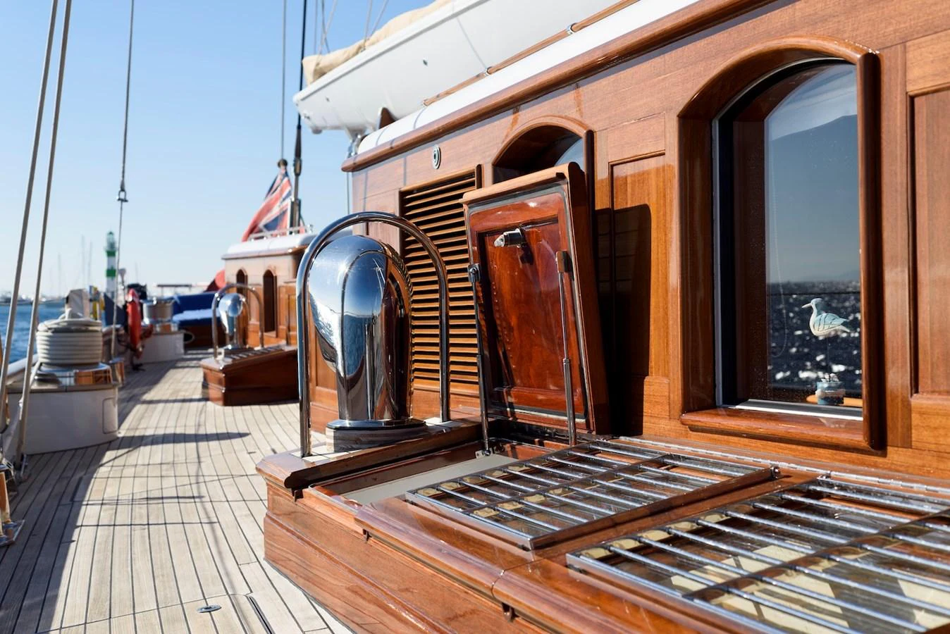A close-up view of the yacht's polished wooden deck and chrome details, showcasing craftsmanship and elegance. aboard METEOR Yacht for Sale