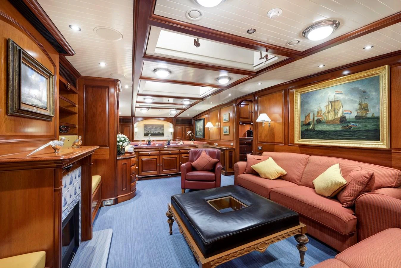 The yacht's salon exudes classic elegance with rich wood paneling and comfortable seating. aboard METEOR Yacht for Sale