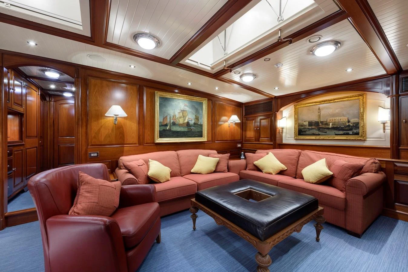 The yacht's salon features plush seating, elegant wood paneling, and tasteful artwork, creating a warm and inviting atmosphere. aboard METEOR Yacht for Sale