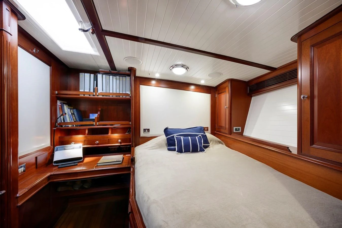 The cozy cabin features a comfortable bed, wooden furnishings, and ample storage space. aboard METEOR Yacht for Sale