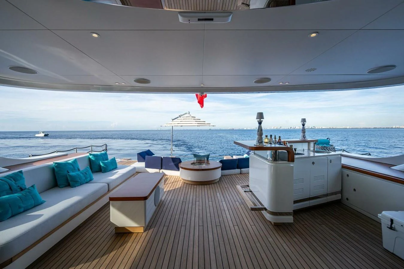 The aft deck offers a spacious and luxurious outdoor lounging area with stunning ocean views. aboard KING'S LAIR Yacht for Sale