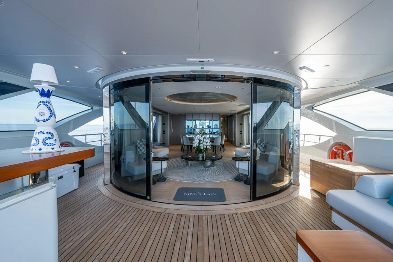 This image showcases the luxurious salon area of the yacht, featuring elegant decor and ample seating. aboard KING'S LAIR Yacht for Sale