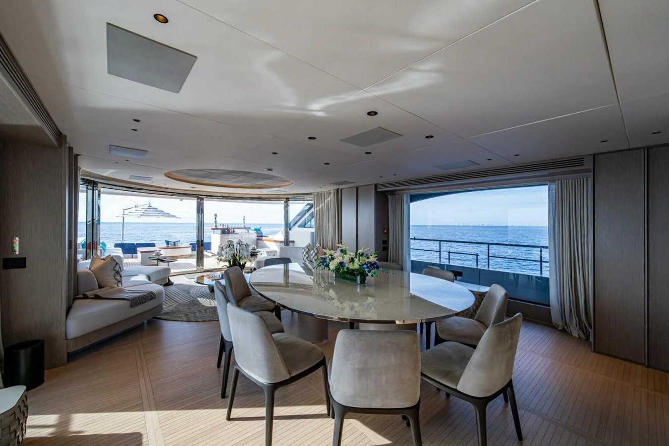 The spacious salon offers panoramic ocean views and elegant dining arrangements. aboard KING'S LAIR Yacht for Sale