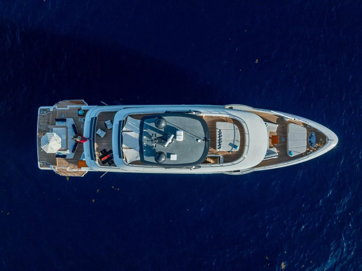 A stunning aerial view of a luxurious yacht cruising on deep blue waters. aboard KING'S LAIR Yacht for Sale