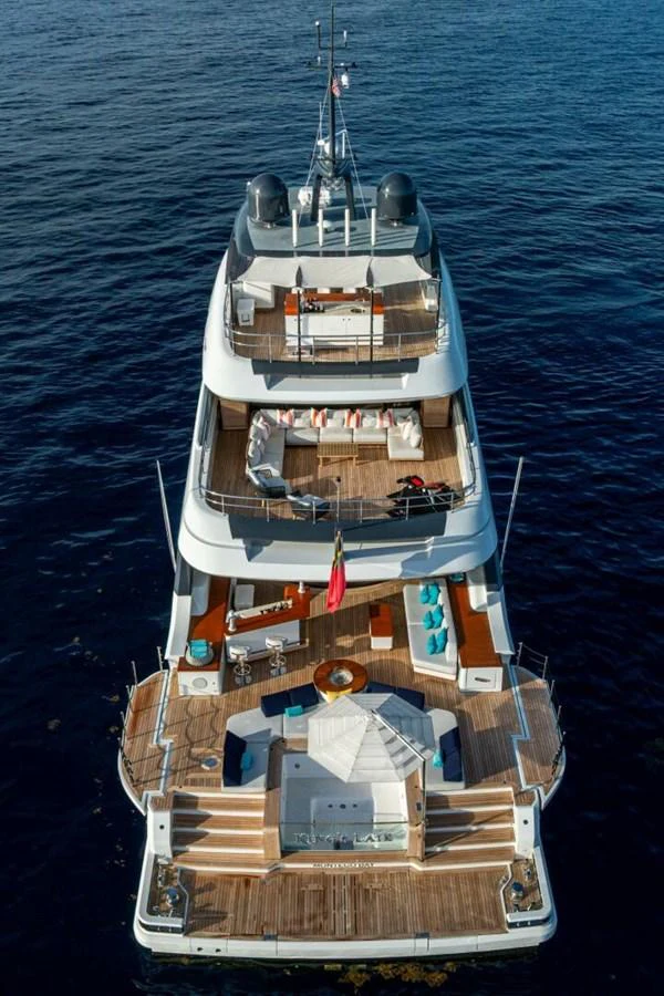 A luxurious multi-deck yacht with spacious outdoor lounging areas and a jacuzzi on the aft deck. aboard KING'S LAIR Yacht for Sale