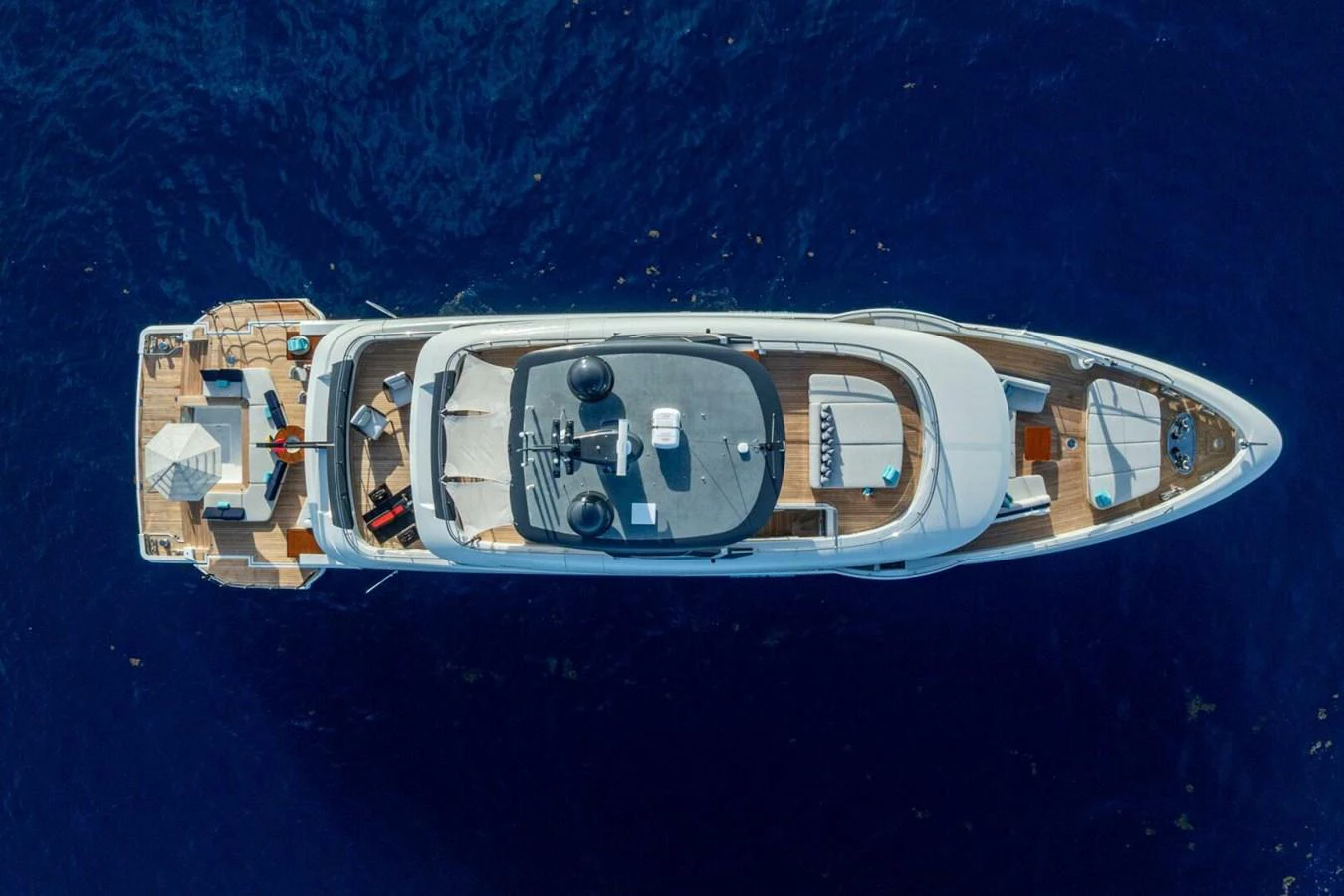 An aerial view of a luxurious yacht cruising on deep blue waters. aboard KING'S LAIR Yacht for Sale