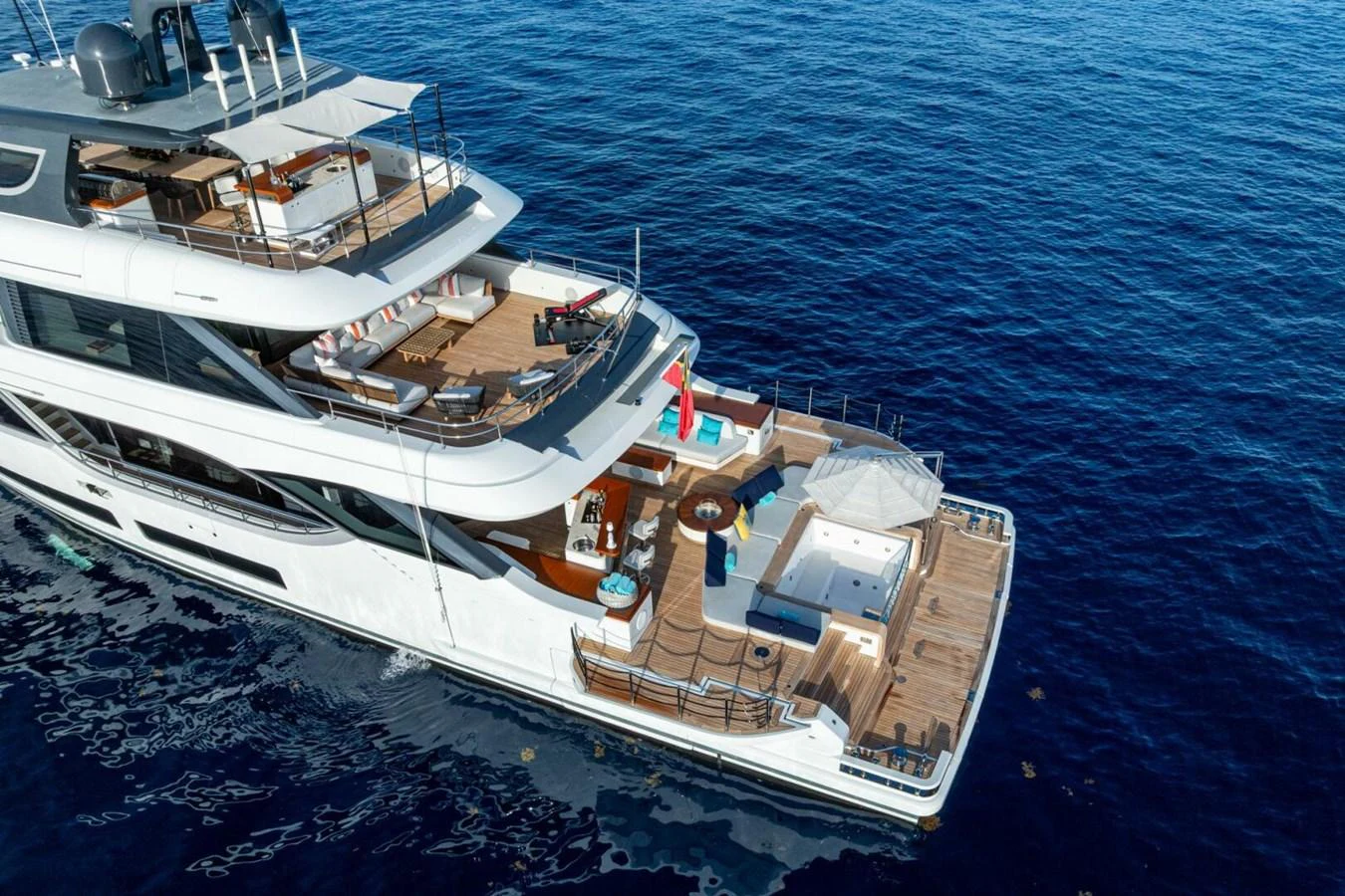 The yacht's aft deck offers luxurious lounging areas and a stunning view of the open sea. aboard KING'S LAIR Yacht for Sale