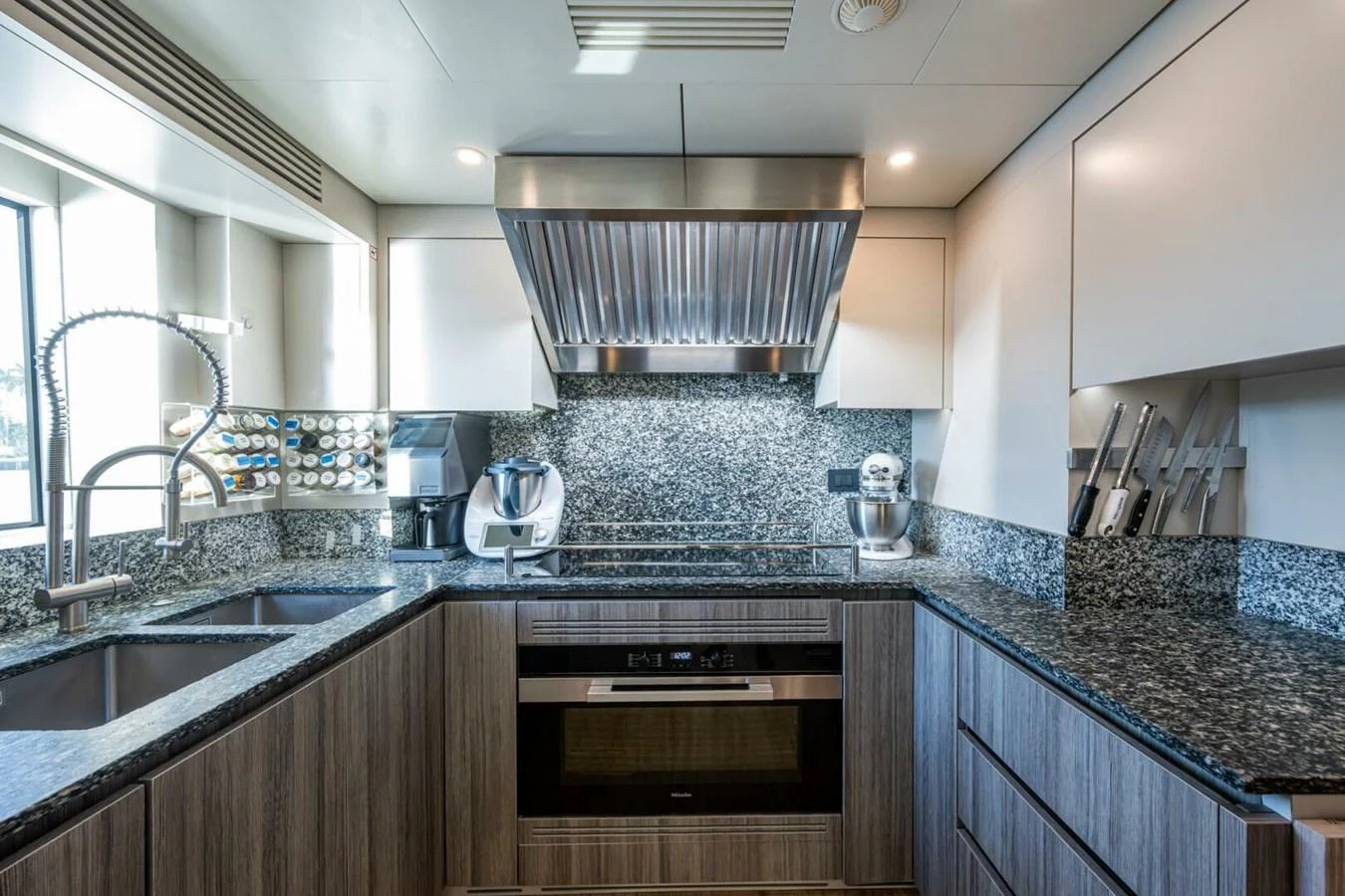 The yacht's galley is equipped with modern appliances and sleek countertops, offering a stylish and functional space for culinary activities. aboard KING'S LAIR Yacht for Sale