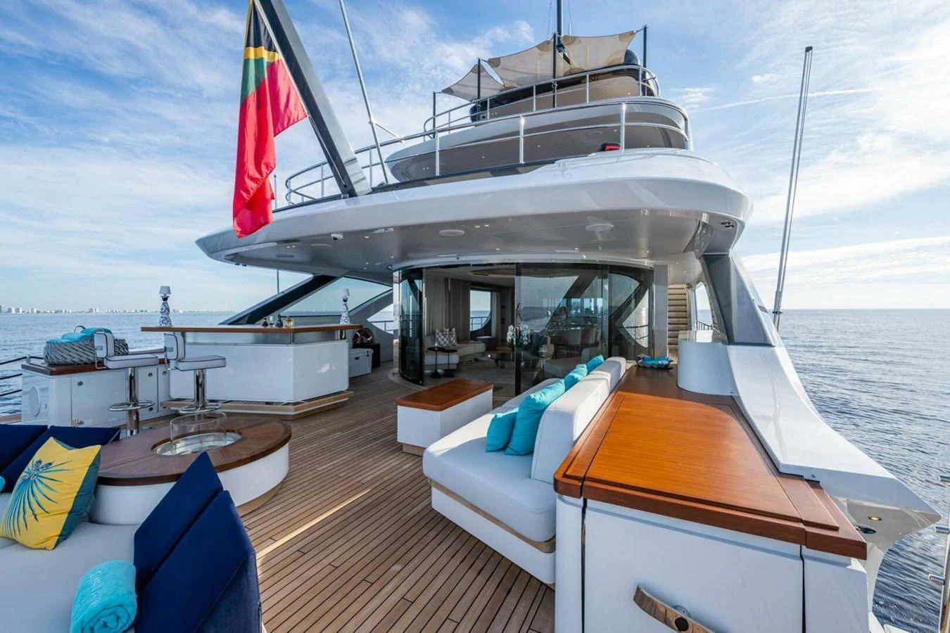 The yacht's aft deck features luxurious seating and a well-equipped bar area, perfect for relaxation and entertainment. aboard KING'S LAIR Yacht for Sale