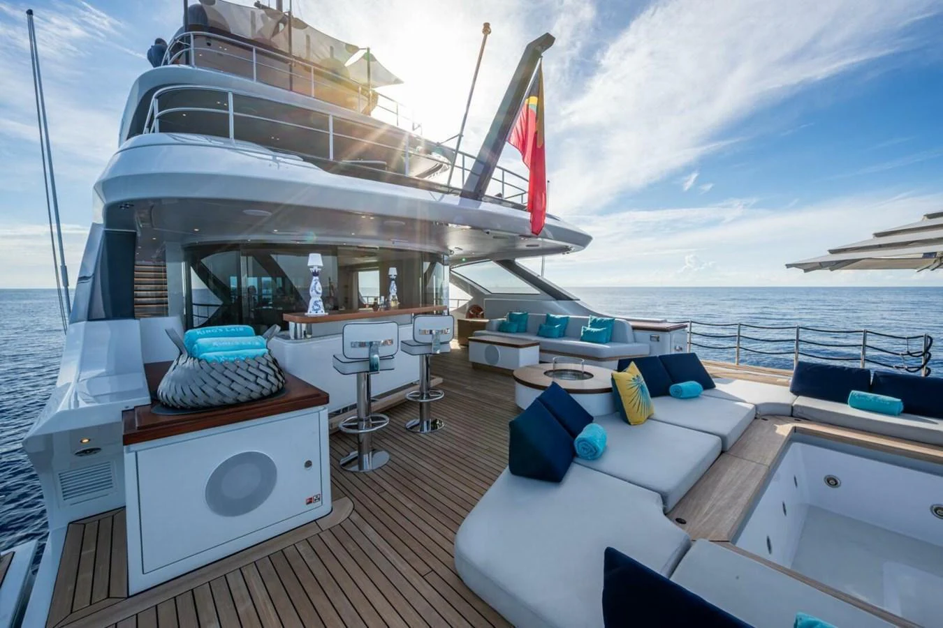 The aft deck offers luxurious seating and a bar area with stunning ocean views. aboard KING'S LAIR Yacht for Sale