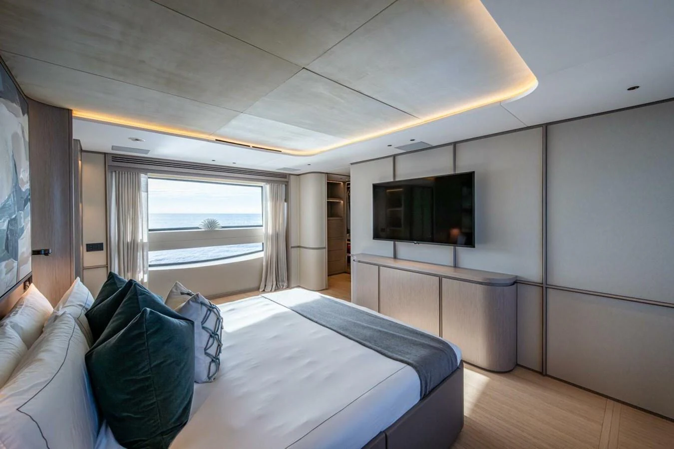 The master stateroom features a spacious bed, large windows, and modern decor. aboard KING'S LAIR Yacht for Sale