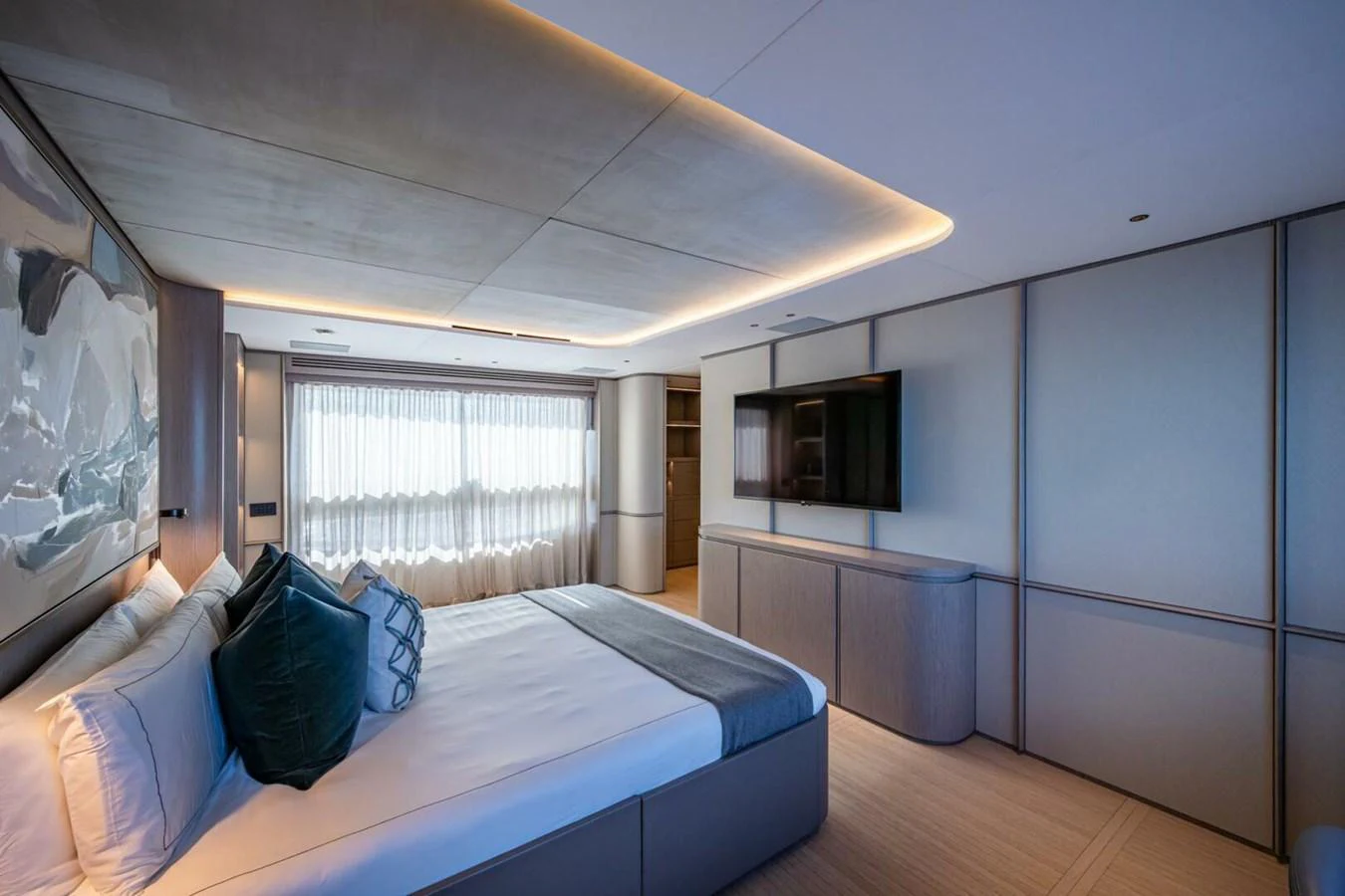 The stateroom features a luxurious bed, modern decor, and ample natural light. aboard KING'S LAIR Yacht for Sale