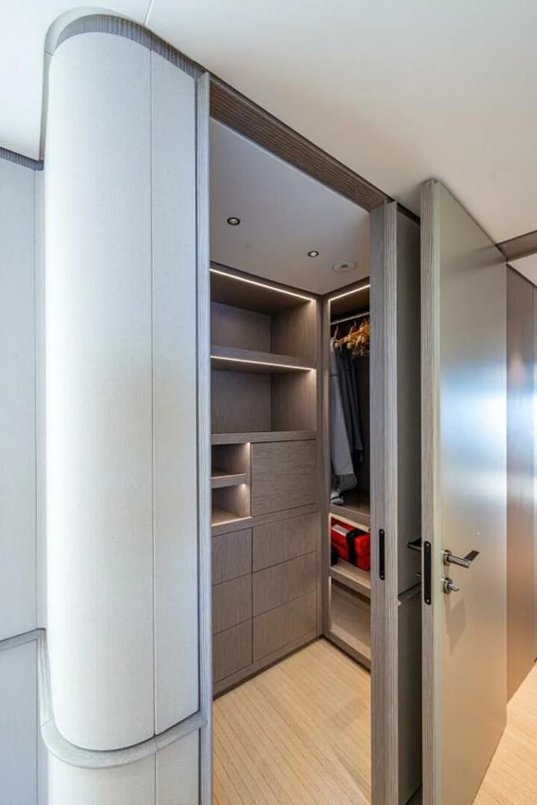 A sleek and modern yacht closet with ample storage space and elegant lighting. aboard KING'S LAIR Yacht for Sale