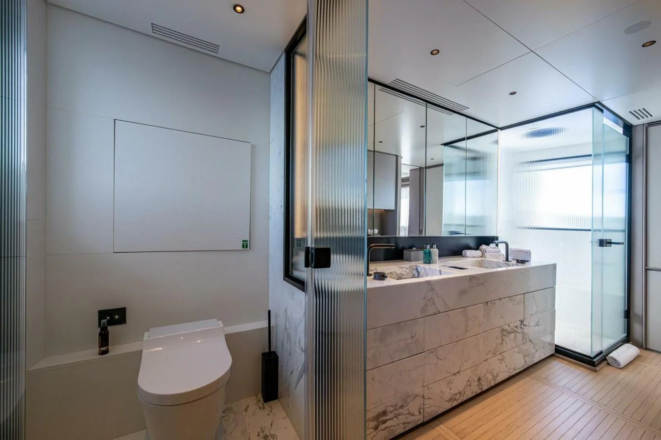 The yacht's bathroom features modern fixtures and a sleek design with marble accents. aboard KING'S LAIR Yacht for Sale