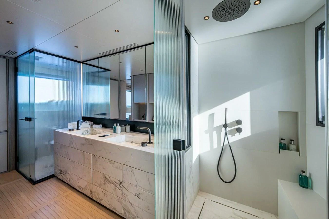 The yacht's bathroom features a sleek, modern design with a spacious shower and elegant marble countertops. aboard KING'S LAIR Yacht for Sale