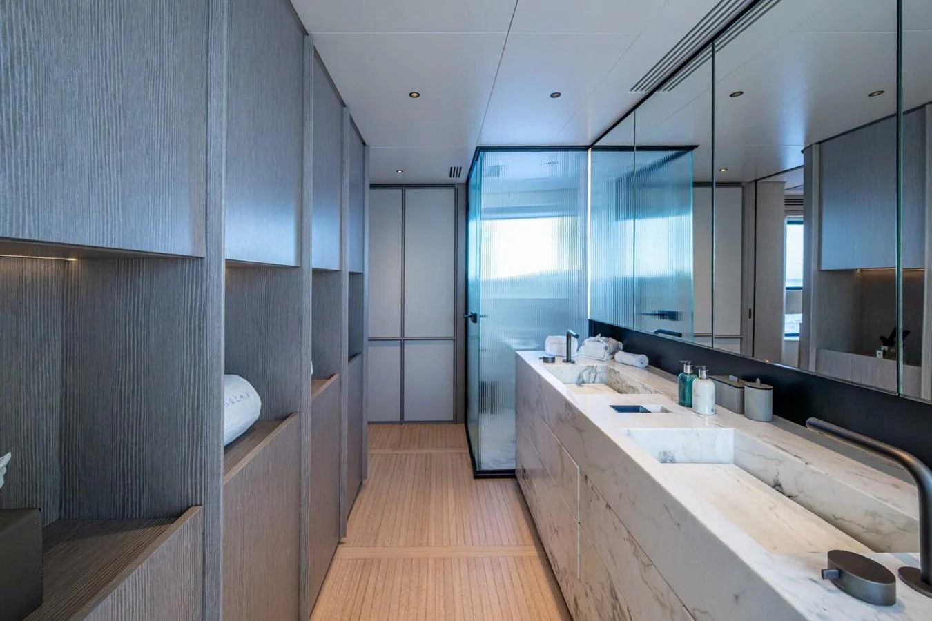 The yacht's bathroom features a sleek, modern design with ample storage and luxurious finishes. aboard KING'S LAIR Yacht for Sale