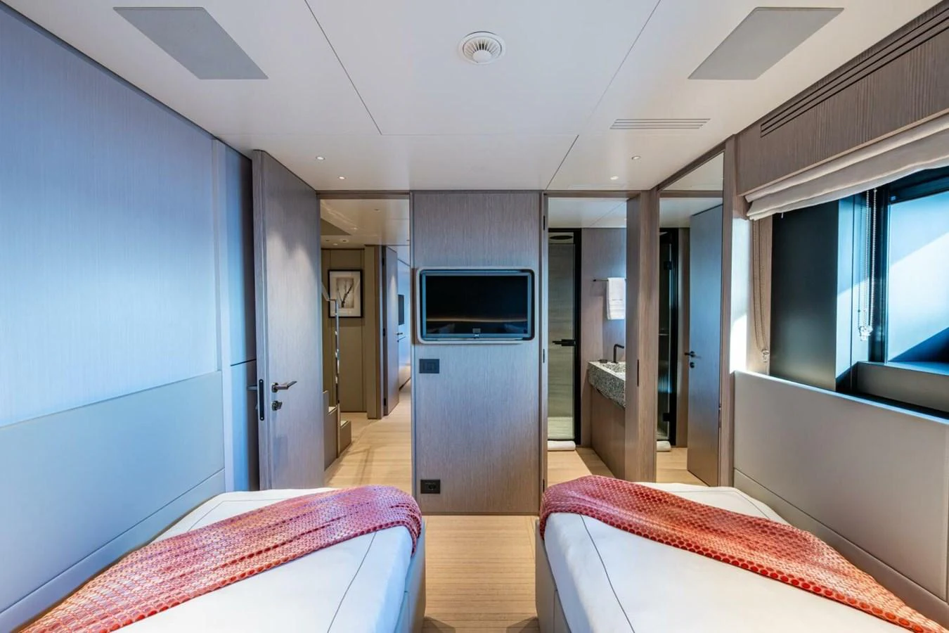 The guest stateroom features twin beds with modern decor and ample natural light. aboard KING'S LAIR Yacht for Sale