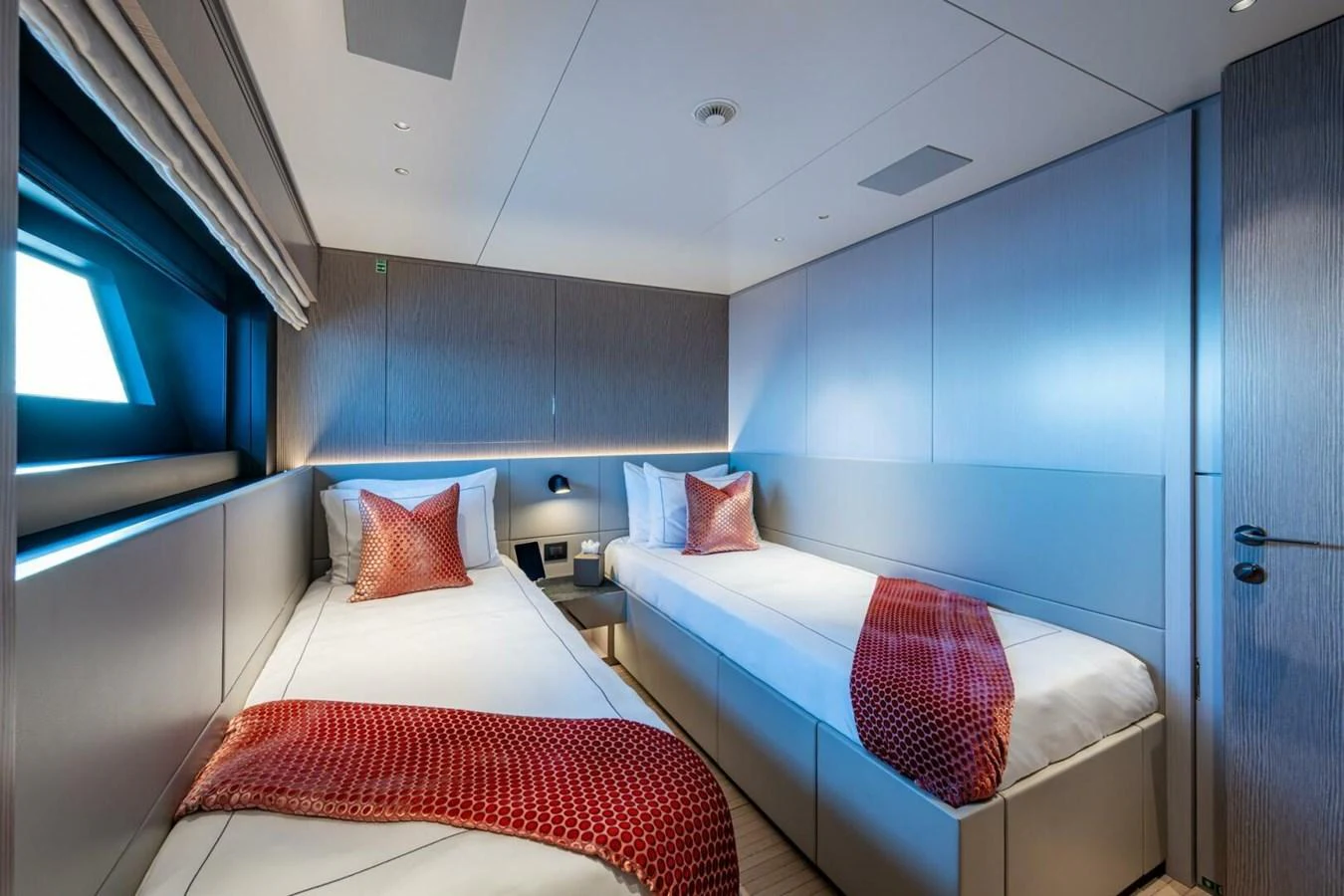 A modern twin stateroom with sleek design and luxurious bedding. aboard KING'S LAIR Yacht for Sale