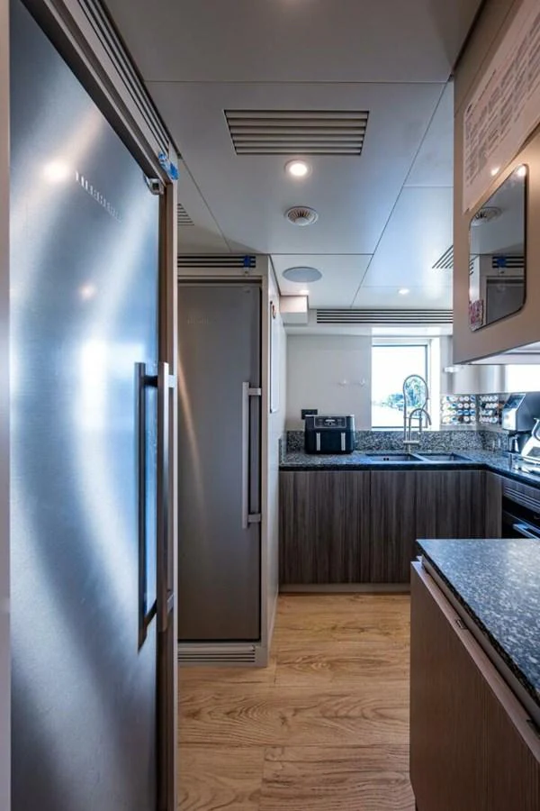The yacht's galley features modern appliances and a sleek design, perfect for gourmet cooking at sea. aboard KING'S LAIR Yacht for Sale