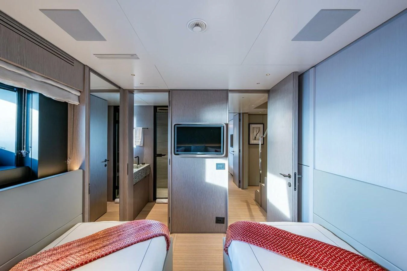 The guest stateroom features twin beds, modern decor, and ample natural light. aboard KING'S LAIR Yacht for Sale